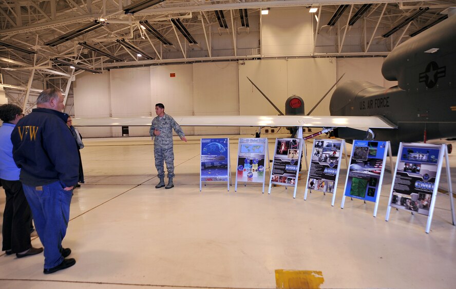 Master Sgt. Raul Lopez, 69th Reconnaissance Group quality assurance superintendent, briefs retirees about the RQ-4 Block 40 Global Hawk's capabilities on Grand Forks Air Force Base, North Dakota, Oct. 16, 2015. About 40 retirees visited the base to attend events planned for Retiree Appreciation Day. (U.S. Air Force photo/Airman 1st Class Bonnie Grantham/Released)