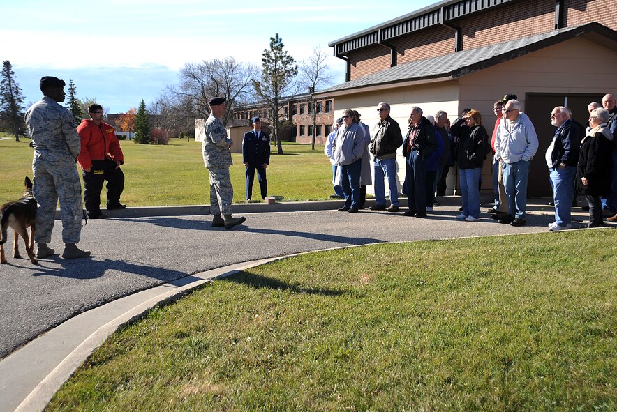 Tech. Sgt. Matthew Byrnes, 319th Security Forces Squadron Military Working Dog section NCO-in-charge, briefs military retirees about the MWD mission at Grand Forks Air Force Base, North Dakota, Oct. 19, 2015. Retirees were invited to the base to attend Retiree Appreciation Day. (U.S. Air Force photo/Airman 1st Class Bonnie Grantham/Released)