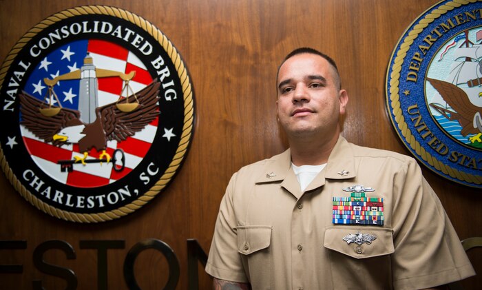 Utilitiesman Second Class (Seabee Combat Warfare/Expeditionary Warfare) Gary Pearson, Navy Consolidated Brig Charleston, poses for a photo Oct. 15, 2015, at the NAVCONBRIG on Joint Base Charleston – Weapons Station, S.C. During the flooding, Pearson’s neighborhood began to take on increasing flood waters. Putting his own safety and needs aside, he safely escorted two neighbors from a flooded home and provided safe passage to an elderly, blind veteran trapped by the flood waters. (U.S. Air Force photo/Airman 1st Class Clayton Cupit)