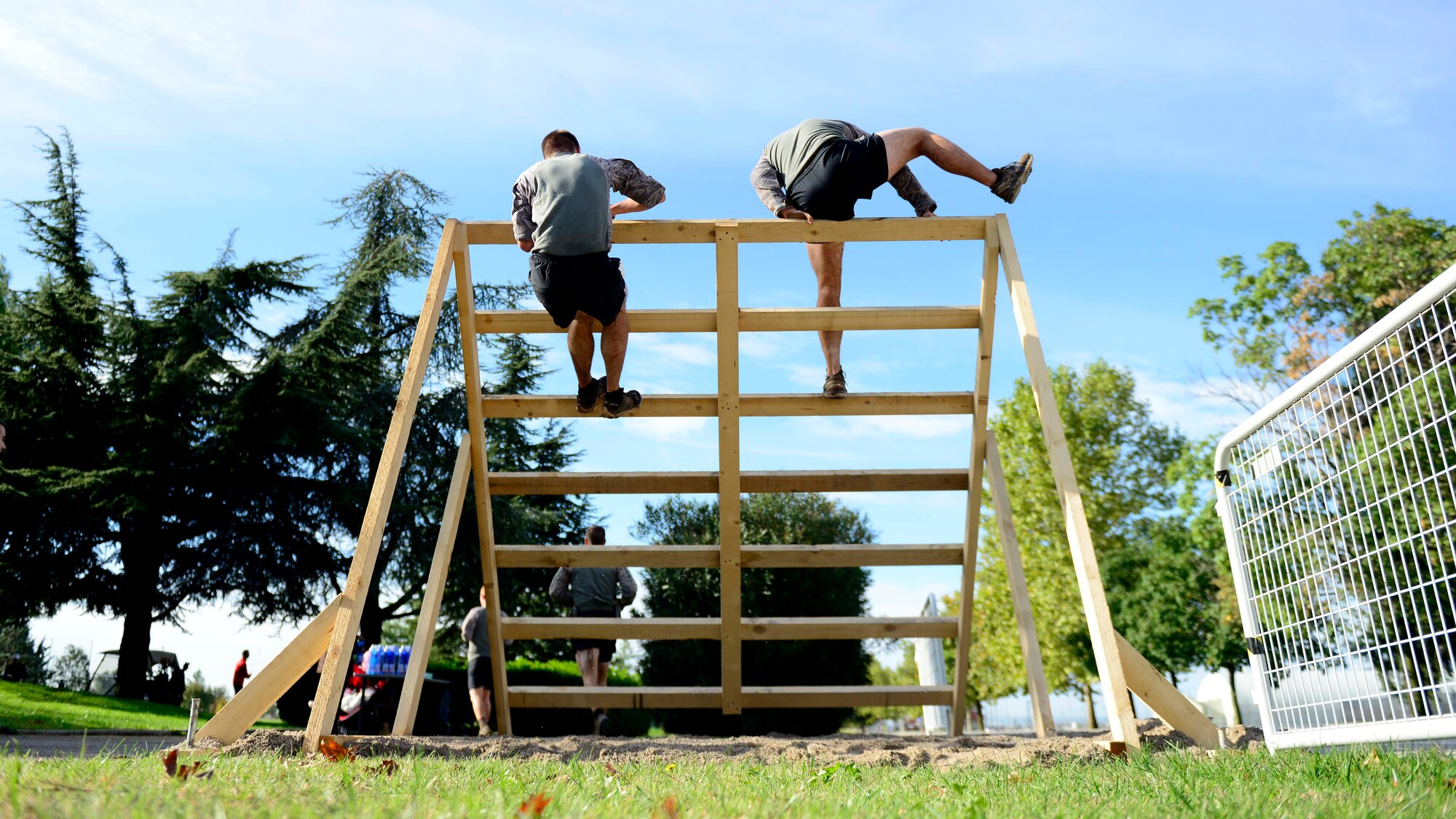 A 31st Security Forces Squadron team climbs an inverted wall during the Wyvern Mud Run, Oct. 17, 2015, at Aviano Air Base, Italy. The six-mile course included 400,000 pounds of mud with more than 12 obstacles, such as T-walls, low crawls and tire flips. (U.S. Air Force photo by Senior Airman Areca T. Bell/Released) 