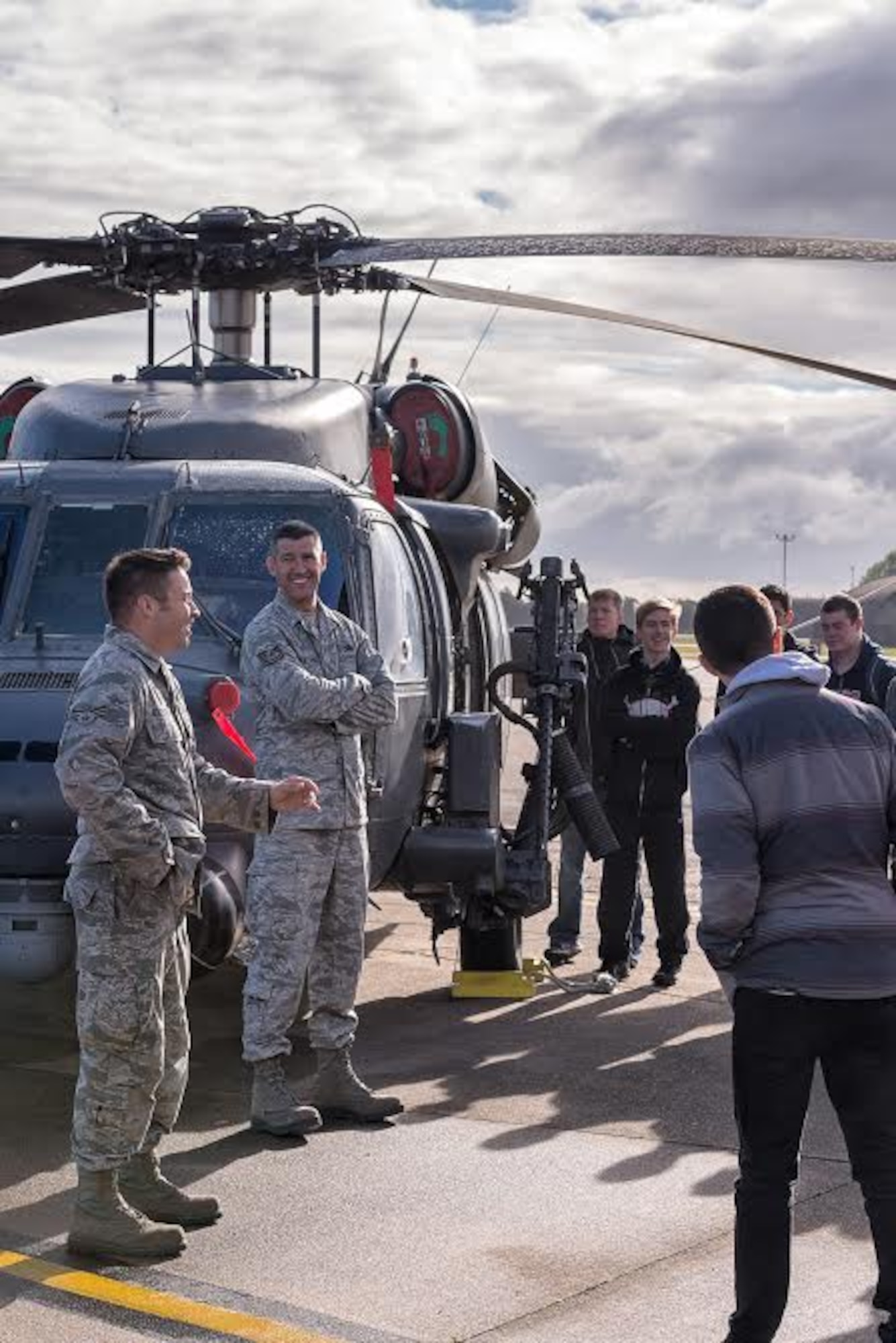 Senior Airman Forrest O’Loughlin, 748th Aircraft Maintenance Squadron dedicated crew chief, and Tech. Sgt. Miguel Montano, 748th AMXS aerospace propulsion technician, recount personal stories of working in the 56th Helicopter Maintenance Unit with Lakenheath High School seniors at Royal Air Force Lakenheath, England, Oct. 14, 2015, during their educational field trip to learn about the mission of the 48th Fighter Wing. The event brought Airmen and the children of military service members together, taking advantage of a great opportunity to share information and bring a better understanding to the students of what their parents roles are as Airmen. (U.S. Air Force photo by Tech. Sgt. Derek Revella/Released)