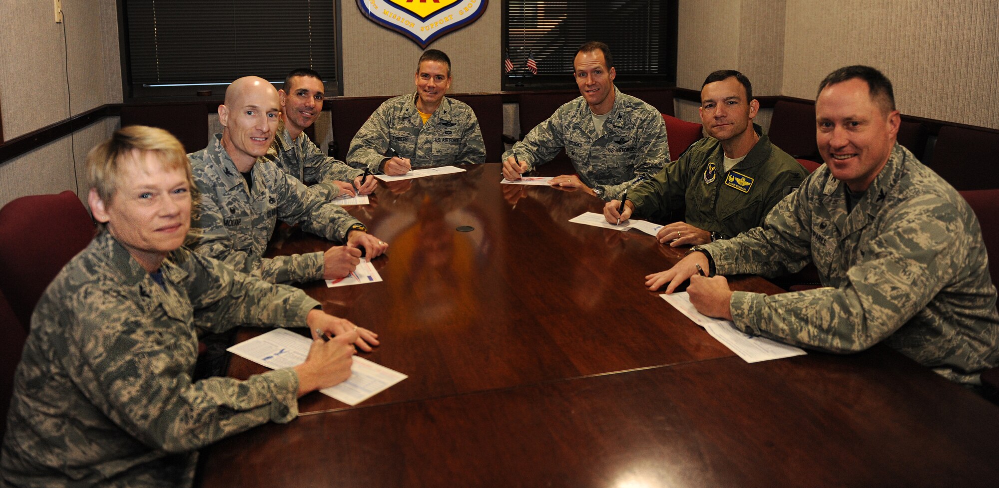 Leadership from the 509th Bomb Wing sign their Combined Federal Campaign (CFC) pledge cards Oct. 16, 2015, at Whiteman Air Force Base, Mo. The CFC is comprised of 141 local campaigns that organize an annual fund raising effort in federal workplaces. (U.S. Air Force photo by Airman 1st Class Michaela R. Slanchik/Released)