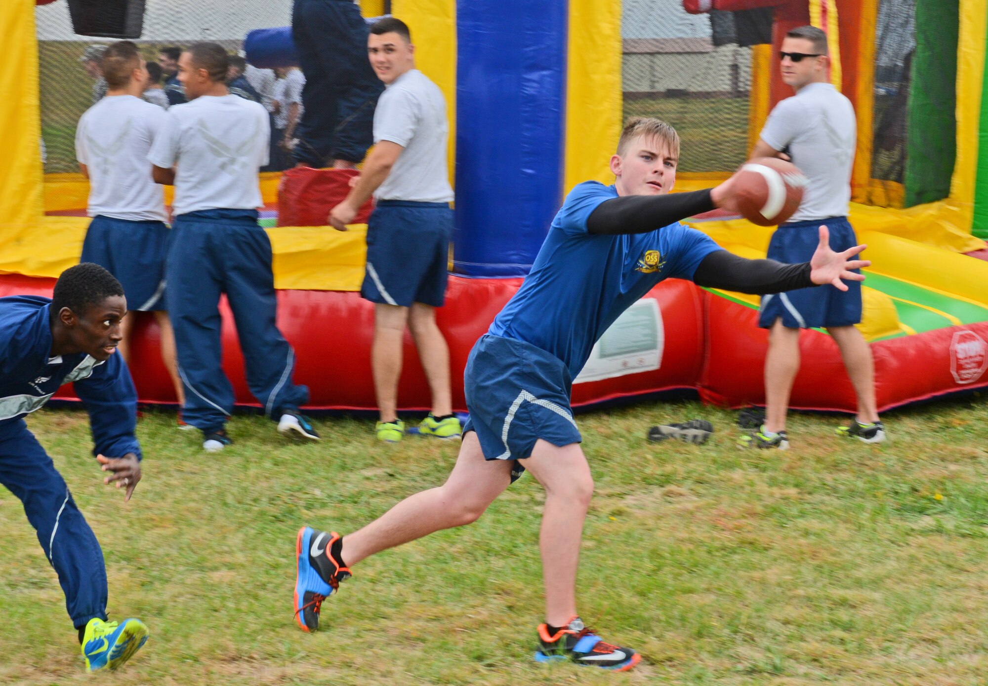 U.S. Air Force Senior Airman Aaron Grantham, 509th Operations Support Squadron, stretches out to catch a pass during a football game on Wingman Day, Oct. 9, 2015 at Whiteman Air Force Base, Mo. The wing held activities that contributed to mental, physical, social and spiritual fitness. (U.S. Air Force photo by Tech. Sgt. Miguel Lara III/Released)