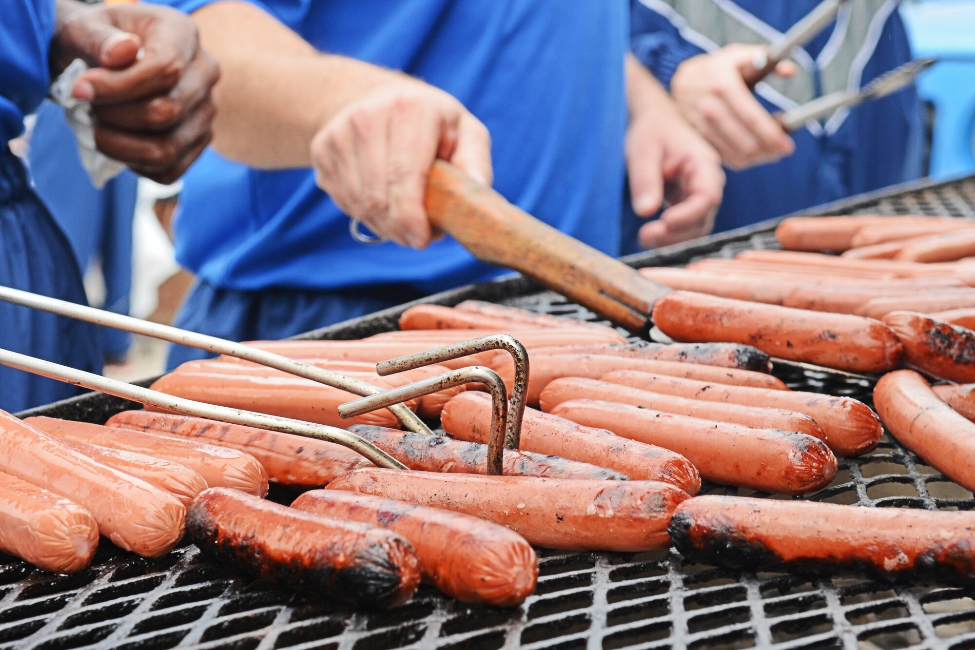 Members of the Whiteman First Sergeants Council cook hot dogs during Wingman Day, Oct. 9, 2015 at Whiteman Air Force Base, Mo. The day included activities such as a wing run, a dodgeball game between the “Chiefs” and “Eagles” and several seminars that focused on resilience. (U.S. Air Force photo by Tech. Sgt. Miguel Lara III/Released)
