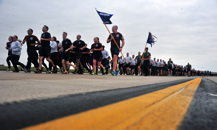 Members of Team Whiteman complete the final stretch of the Wingman Day flightline run at Whiteman Air Force Base, Mo., Oct. 9, 2015. Events were held throughout the day to strengthen and sustain a resilient Air Force community that values mental, physical, social, and spiritual fitness. (U.S. Air Force photo by Airman 1st Class Jovan Banks/Released)