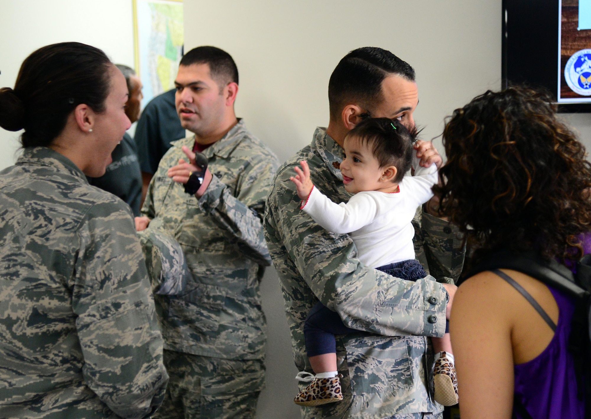 Airmen and their families gather at a reception for the new Airman and Family Readiness Center Oct. 16, 2015, at Malmstrom Air Force Base, Mont. The A&FRC focuses on offering programs to improve life for both Airmen and their dependents. (U.S. Air Force photo/Airman 1st Class Magen M. Reeves)