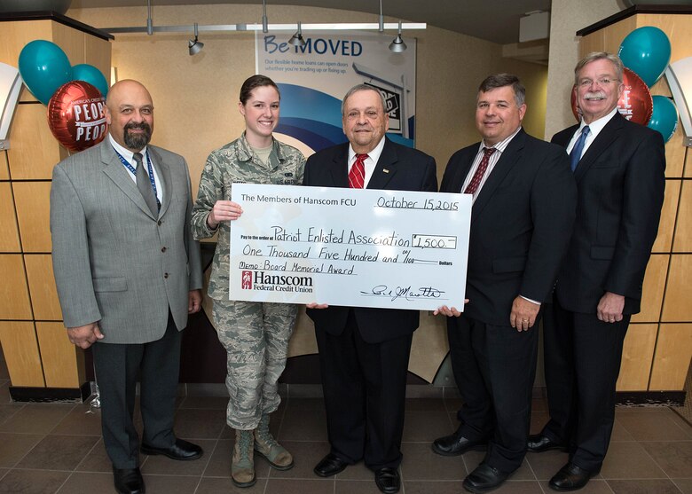 Senior Airman Kara Watts, Patriot Enlisted Association president, stand for a photo after being presented the Hanscom Federal Credit Union Board of Director’s Memorial Award on behalf of the PEA by Paul Marotta, center, HFCU chairman of the board, and David Sprague, far right, HFCU CEO, at the credit union Oct.15, as John Delcore, far left, HFCU secretary, and Tom Fredericks, 66th Air Base Group deputy director, stand also. The award is presented to a Hanscom private military connected service organization. (U.S. Air Force photo by Jerry Saslav)