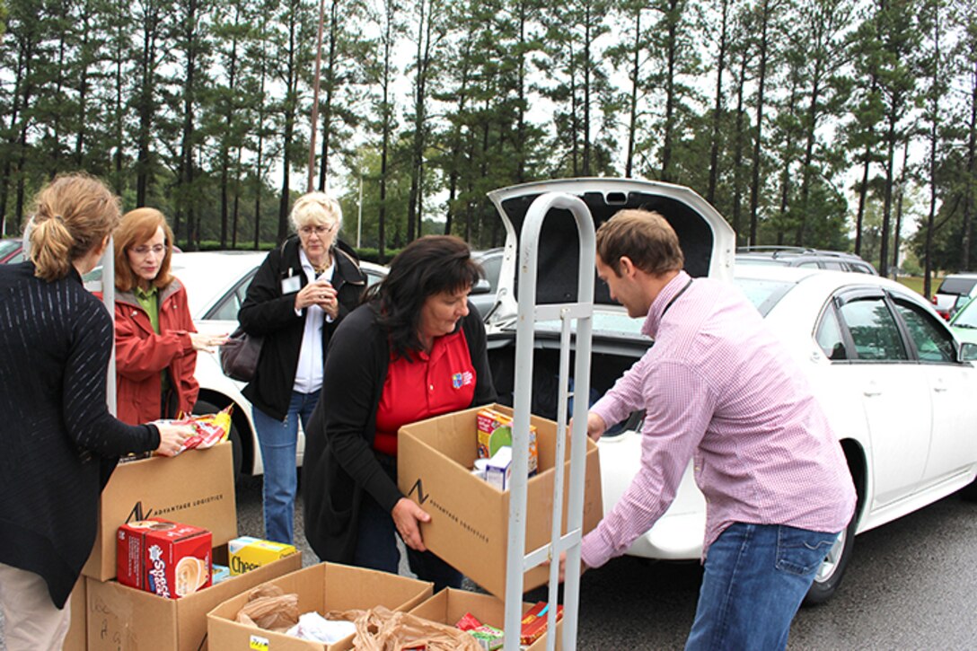 AEDC team members assist volunteers with the Good Samaritan of Tullahoma load boxes of food donated as part of the Complex’s Feds Feed Families campaign. Feds Feed Families is an Air Force wide campaign, which AEDC team members have been participating in for the past four years to provide food and other necessities to families in the area who are in need of assistance. Pictured left to right are Shannon Allen, AEDC; Kathy Pelton, Good Samaritan Tullahoma; Pat Crosslin, Good Samaritan Tullahoma; and Peggy Proffitt and William Mallory, AEDC. (Photo by Deidre Ortiz)