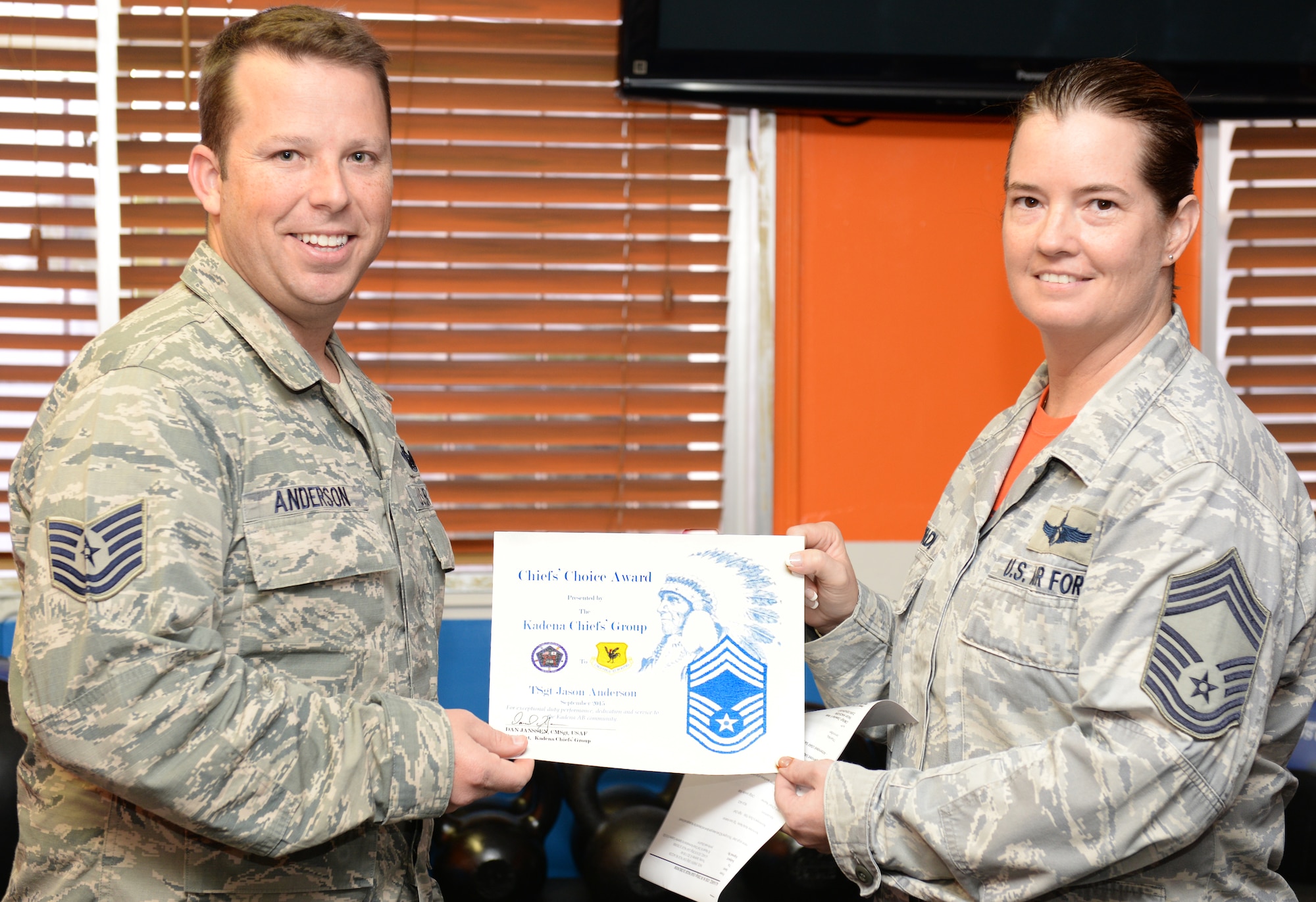 Air Force Tech. Sgt. Jason Anderson, 961st Airborne Air Control Squadron flight chief, is presented the Chief’s Choice Award by Air Force Chief Master Sgt. Jennifer Wade, 961st AACS superintendent, at the 961st AACS Oct. 16, 2015, on Kadena Air Base, Japan. Anderson earned the Chief’s Choice Award for September. (U.S. Air Force photo by Senior Airman Omari Bernard)