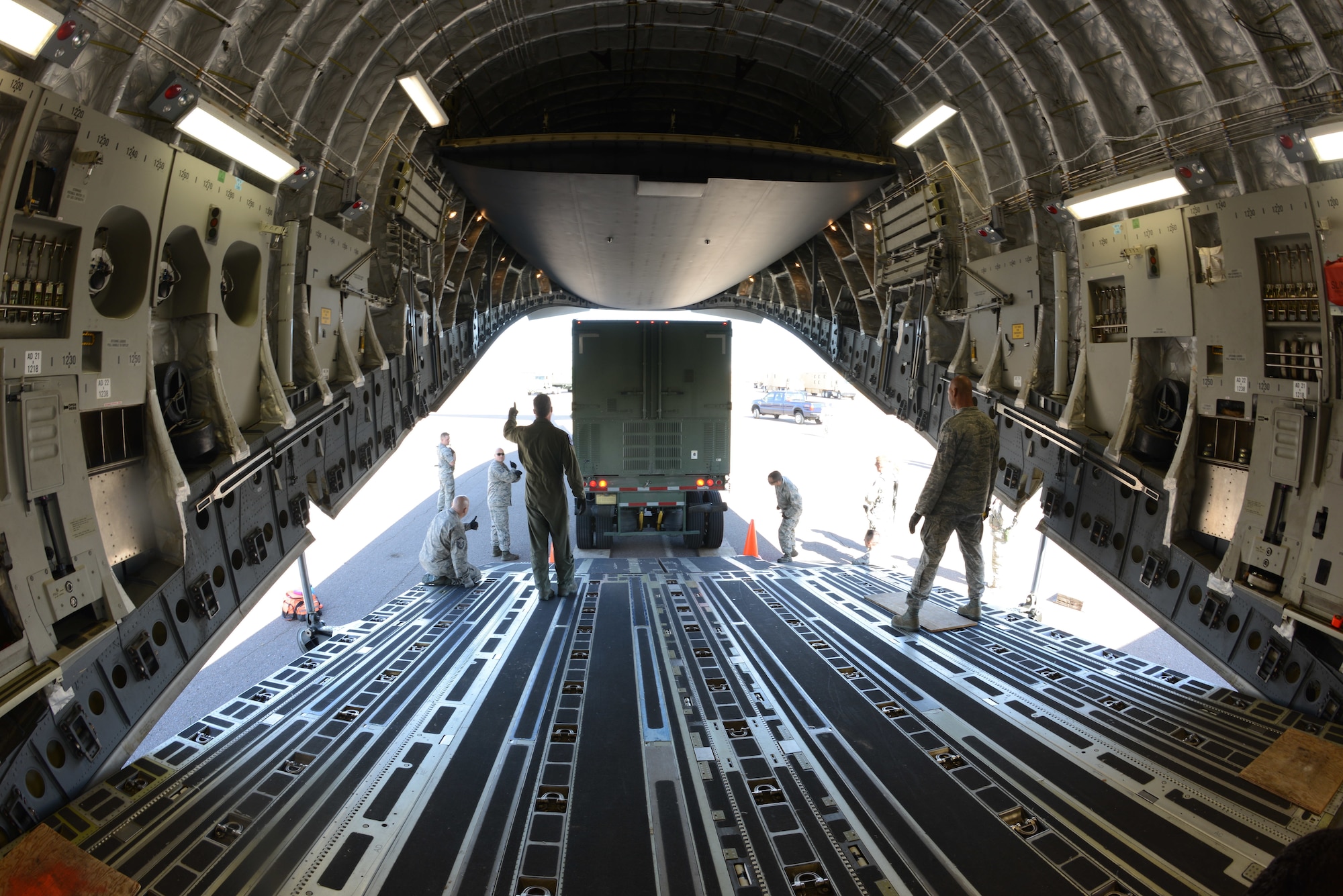 Colorado Air National Guard Airmen from the 233d Space Group, Greeley Air National Guard Station, load a Mission Vehicle 118 onto a C-17 Globemaster III at Buckley Air Force Base, Colo., Oct. 17, 2015. This exercise is part of the 140th Wing’s four-day wartime readiness inspection, which is an implementation of the new Air Force Inspection System, and will assess the wing's ability to perform their combat missions. (U.S. Air National Guard photo by Tech. Sgt. Nicole Manzanares)