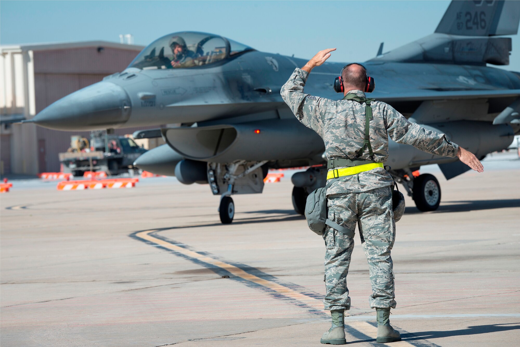 U.S. Air Force Tech. Sgt. Robbin Bruning, 140th Maintenance Squadron, Colorado Air National Guard, ushers in an F-16 Fighting Falcon during the wing’s readiness inspection at Buckley Air Force Base, Aurora, Colo., Oct. 16, 2015. This training is a part of the 140th Wing’s four-day Wing Wartime Readiness Inspection, the U.S. Air Force’s new evaluation system for wartime, contingency and force sustainment readiness. (U.S. Air National Guard photo by Tech. Sgt. Wolfram M. Stumpf)
