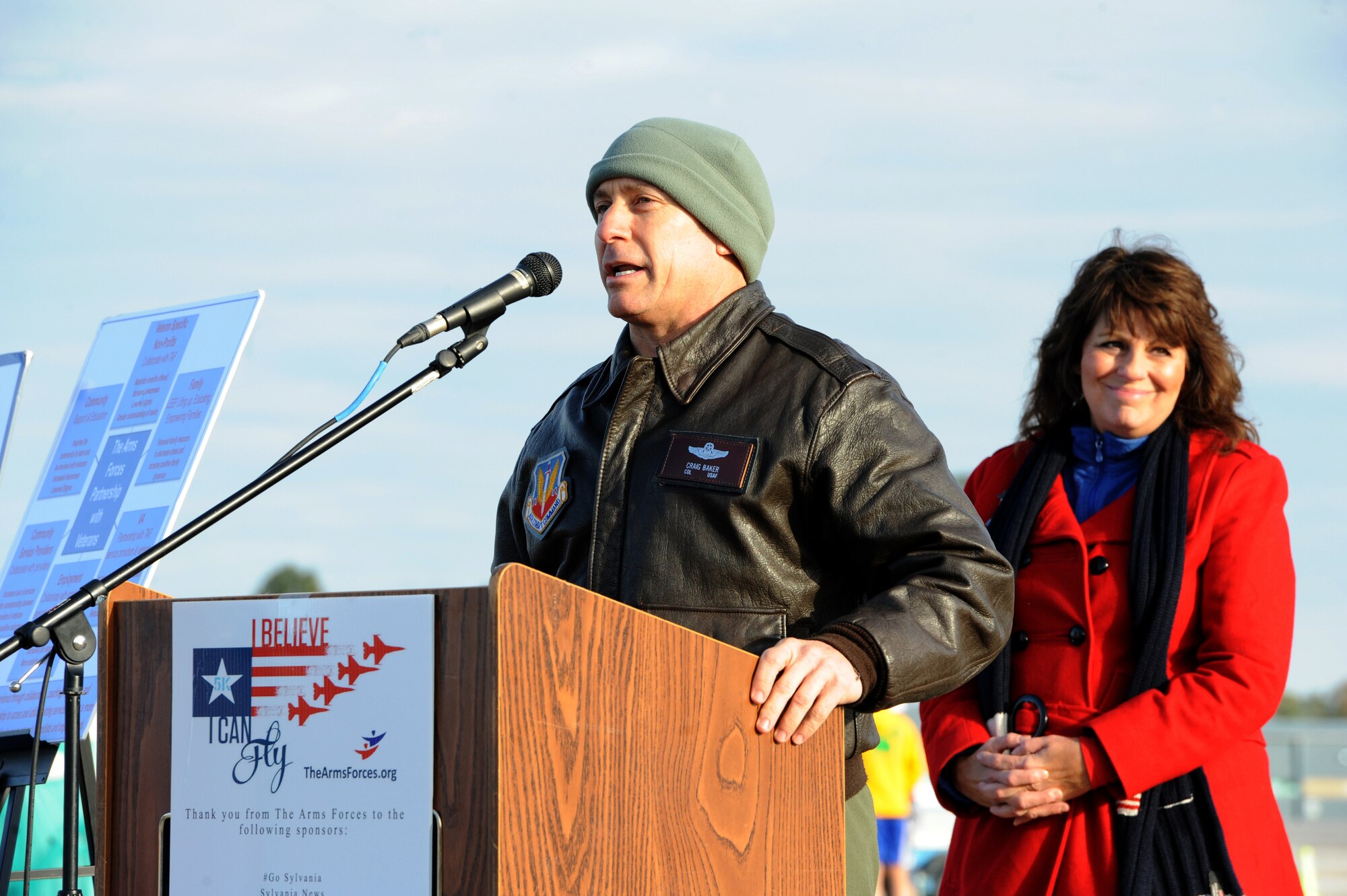Col. Craig Baker, 180th Fighter Wing commander and Pam Hayes, founder of The Arms Forces and coordinator of the I Believe I Can Fly 5k, address runners and supporters before the race Oct. 18, 2015 in Swanton, Ohio.  Men and Women of the 180th FW traded combat boots for running shoes, joining local community members in a 5k race, hosted by the Arms Forces Organization, raising awareness about traumatic brain injuries. The Arms Forces provides education and programs allowing veterans past and present, who have a traumatic brain injury or post-traumatic stress disorder to find understanding, purpose and direction as they face the other war while living at home with their invisible injury. Air National Guard Photo by Staff Sgt. John Wilkes/Released.