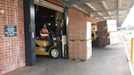 A DLA Distribution Albany employee moves a pallet of MRE’s to be shipped to Fort Jackson, S.C., to aid in the Hurricane Joaquin disaster relief.