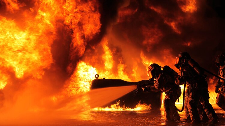 Battling the heat from the flames, Aircraft Rescue and Firefighting Marines extinguish some of their first fuel fires at Marine Corps Air Station Cherry Point, N.C., Oct. 16, 2015. The training exercise taught the new Marines to battle the heat and keep pushing until they annihilate the flames, as well as get used to the environment of a real fire. 