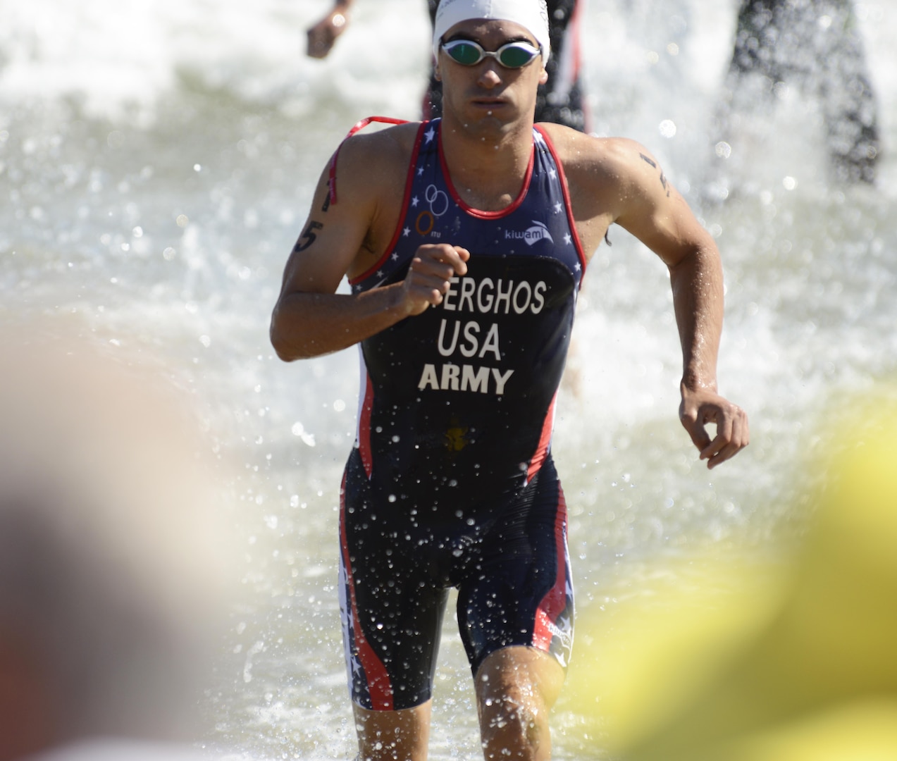 Army Capt. Nicholas Sterghos runs out of the surf during the 1.5-kilometer swim leg of the men's triathlon in downtown Pohang, South Korea, during the CISM World Games Oct. 10, 2015.