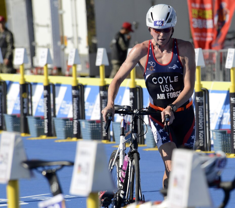 U.S. Air Force Maj. Judith Coyle pulls her bike out of the rack to begin the 40-kilometer cycling leg of the women's triathlon in Pohang, South Korea, during the CISM World Games Oct. 10, 2015. Coyle earned a bronze medal in the women's senior division.