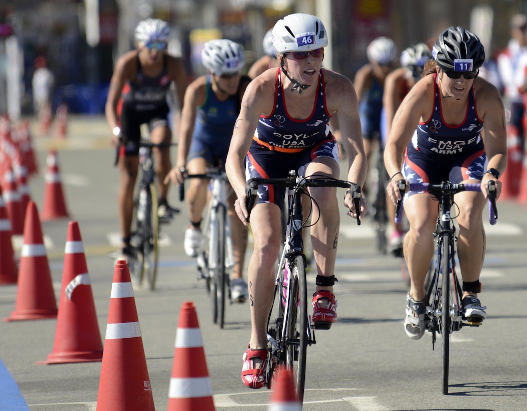 U.S. Army 2nd Lt. Justine Emge (right) and Air Force Maj. Judith Coyle race the 40-kilometer cycling leg of the women's triathlon in downtown Pohang, South Korea during the CISM World Games Oct. 10, 2015. Coyle earned bronze for the USA with an overall time of two hours, 15 minutes and 27.69 seconds in the triathlon.
