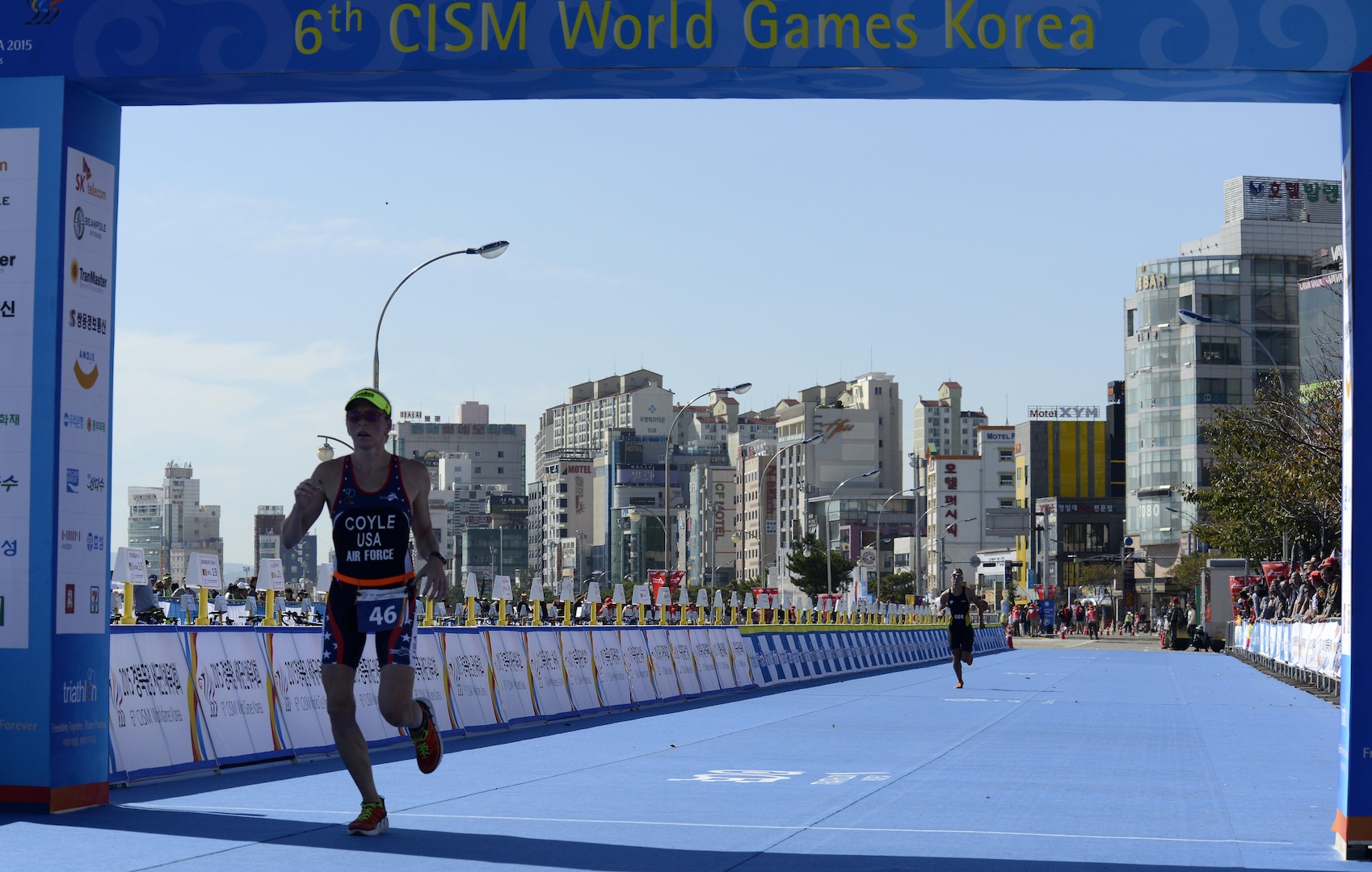 U.S. Air Force Maj. Judith Coyle crosses the finish line of the women's triathlon in downtown Pohang, South Korea, during the CISM World Games Oct. 10, 2015. Coyle earned bronze for the USA in the seniors division with an overall time of two hours, 15 minutes and  27.69 seconds.