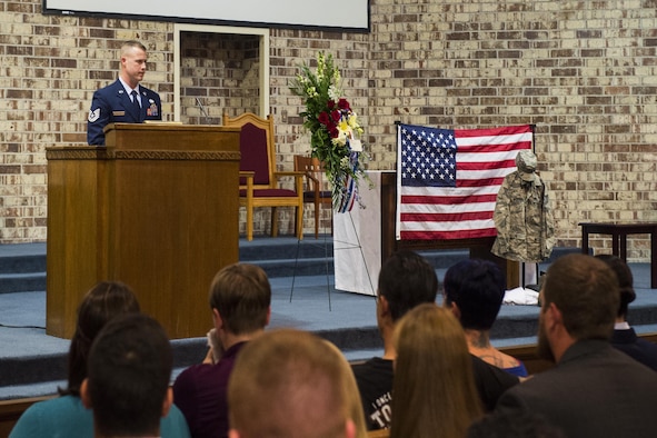 Tech. Sgt. Michael Sessions, the 723rd Aircraft Maintenance Squadron assistant first sergeant, addresses Airman, family and friends in attendance during Tech. Sgt. Marissa Hartford’s memorial ceremony at the base chapel on Moody Air Force Base, Ga., Oct. 16, 2015. Sessions emphasized what an honor it was to serve alongside Hartford and the mark she left on his life and others. (U.S. Air Force photo/Senior Airman Ceaira Tinsley)