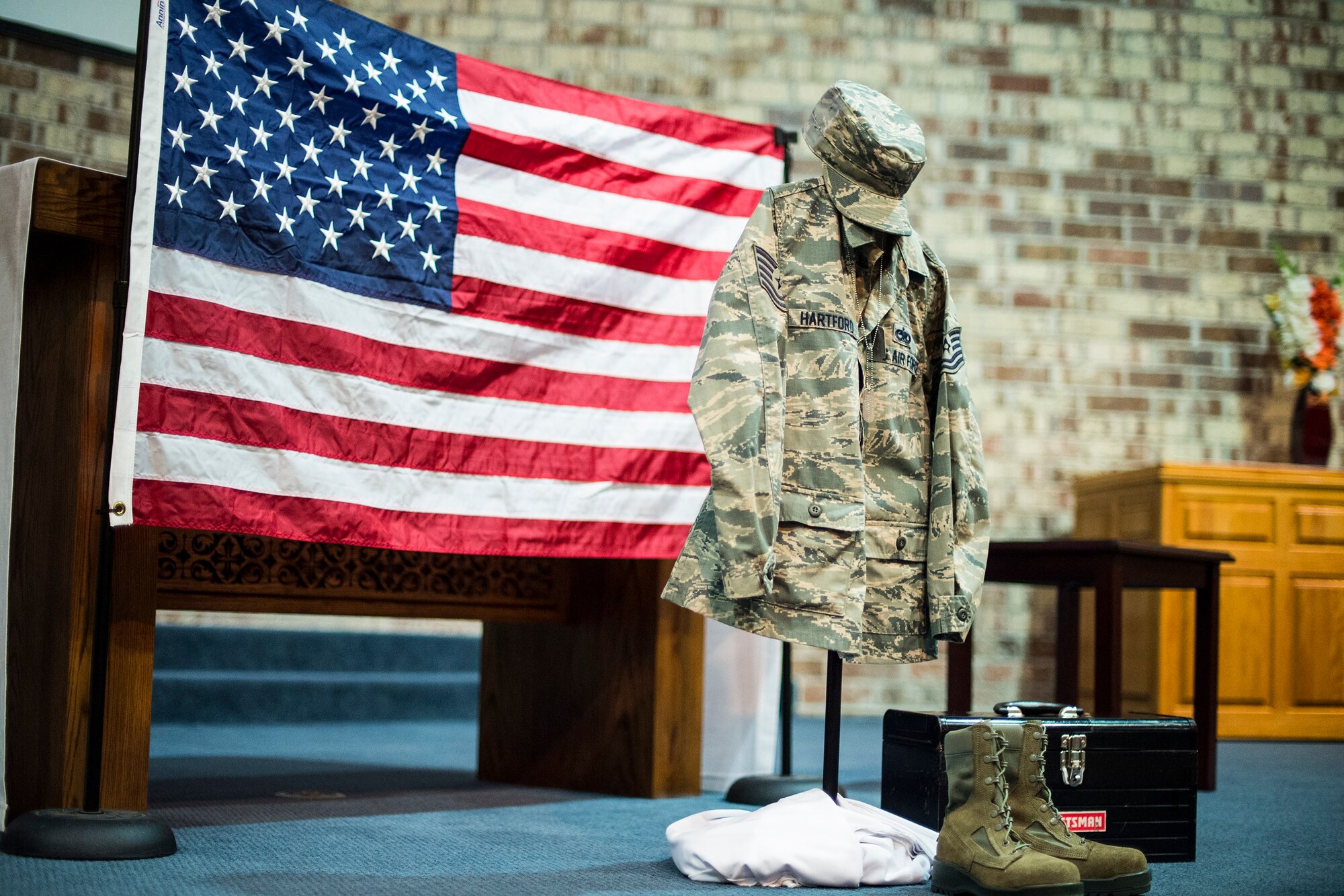 A memorial display for Tech. Sgt. Marissa Hartford rests at the altar during her memorial ceremony at the base chapel on Moody Air Force Base, Ga., Oct. 16, 2015. Hartford was assigned to Moody AFB for nine years and deployed once to Djibouti, Africa. (U.S. Air Force photo/Senior Airman Ceaira Tinsley)