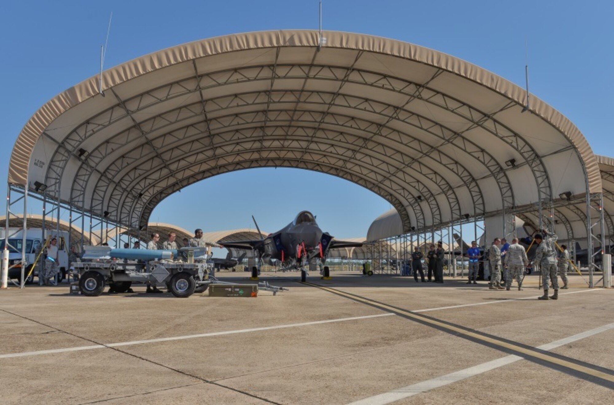 Observers watch as the 33rd Aircraft Maintenance Squadron participates in the first on the F-35A Lightning II at Eglin Air Force Base, Fla., Oct. 16, 2015. This is the 33rd Fighter Wings first flightline weapons load since transitioning from legacy aircraft like the F-15 Eagle in 2009. (U.S. Air Force Photo/Senior Airman Andrea Posey)