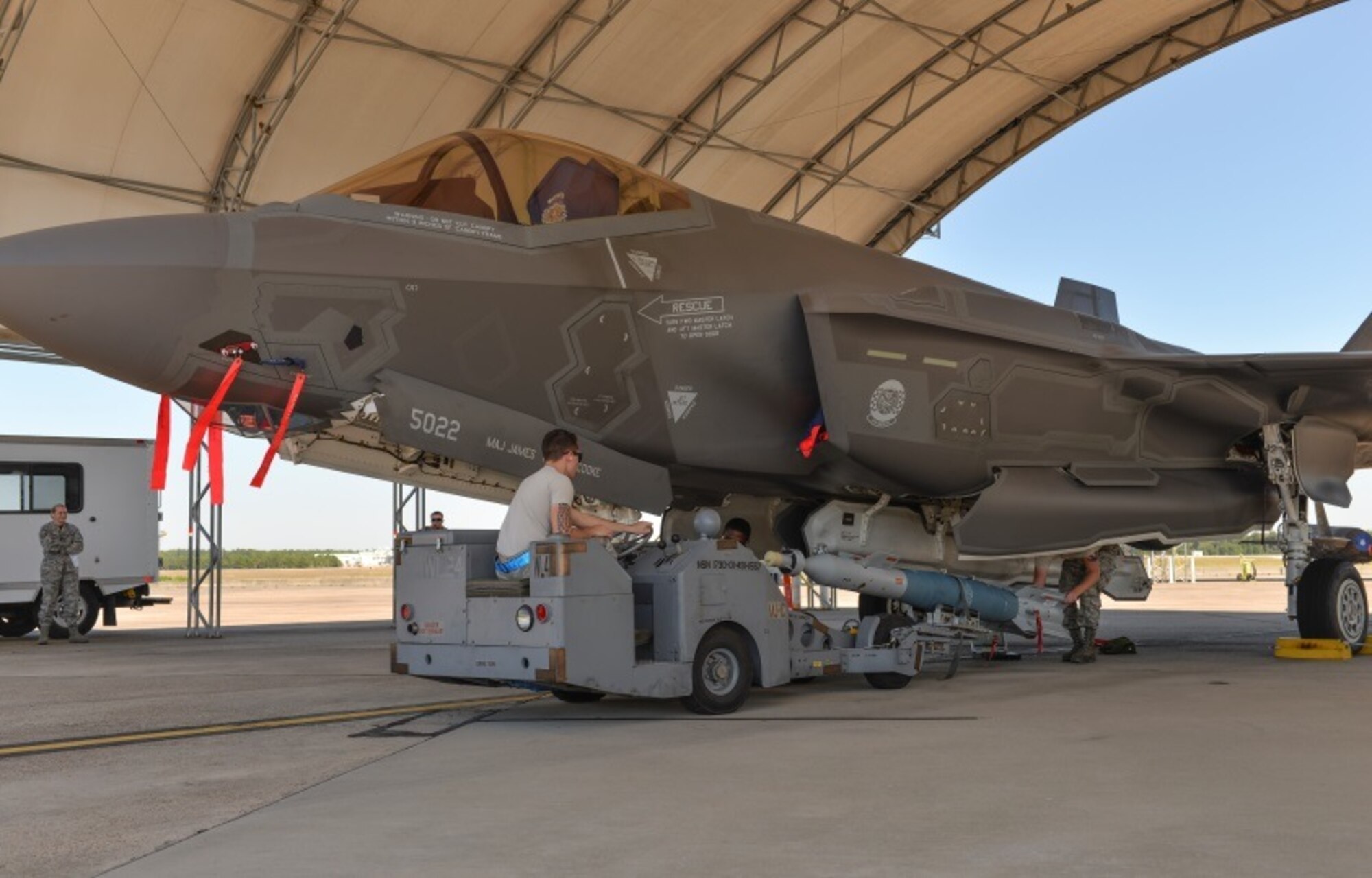 33rd Aircraft Maintenance Squadron personnel load a missile-guided bomb unit into an F-35A Lightning II at Eglin Air Force Base, Fla., Oct. 16, 2015. Flightline munitions load training allows load crews to perform in a more realistic work environment. (U.S. Air Force Photo/Senior Airman Andrea Posey)