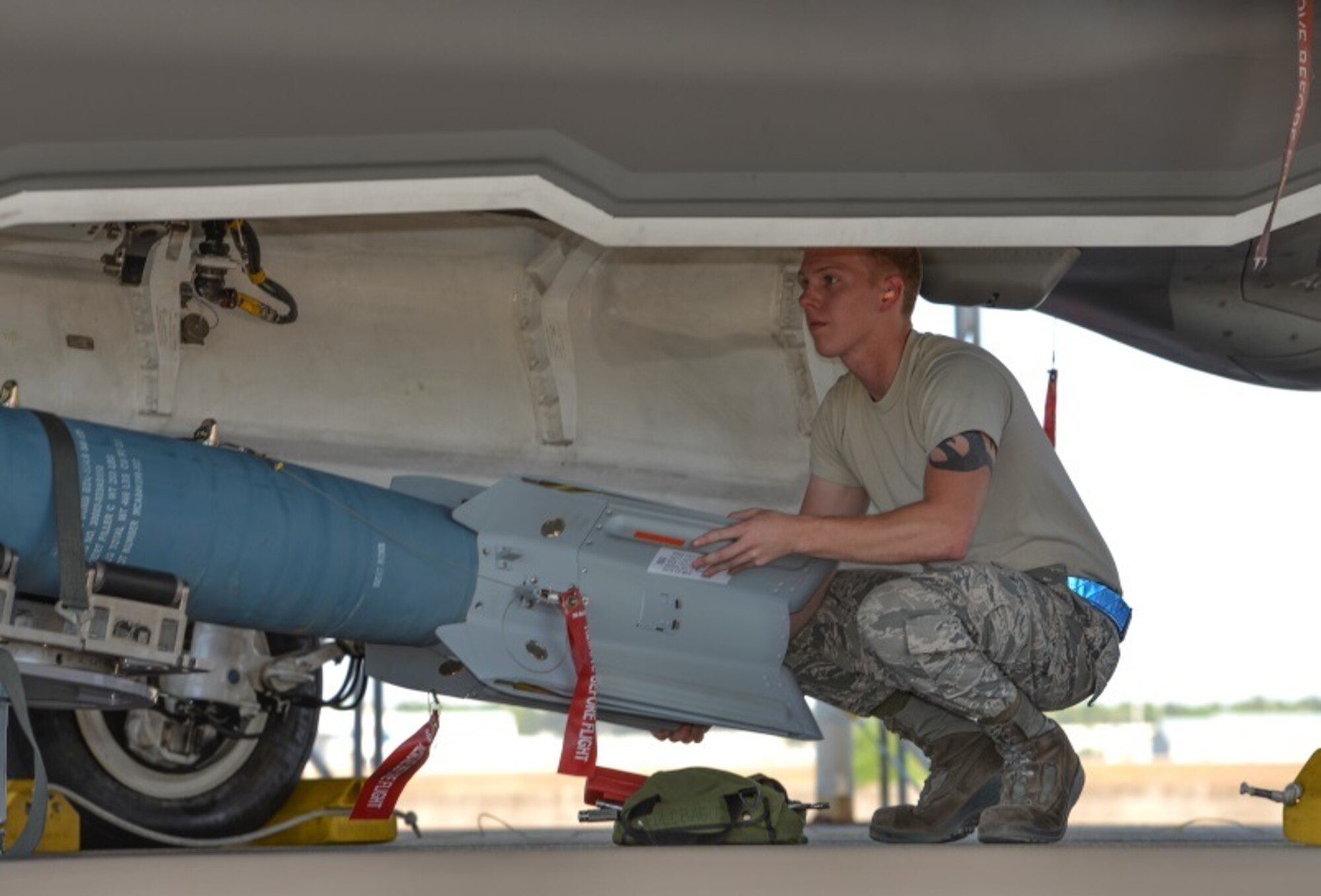 Airmen 1st Class Zachery Justice, 33rd Aircraft Maintenance Squadron load crew member, moves a missile-guided bomb unit into position to load into the F-35A Lightning II at Eglin Air Force Base, Fla., Oct. 16, 2015. Weapons load Airmen worked in stages to assemble and move the missile into the proper position for safe load into the aircraft. (U.S. Air Force Photo/Senior Airman Andrea Posey)