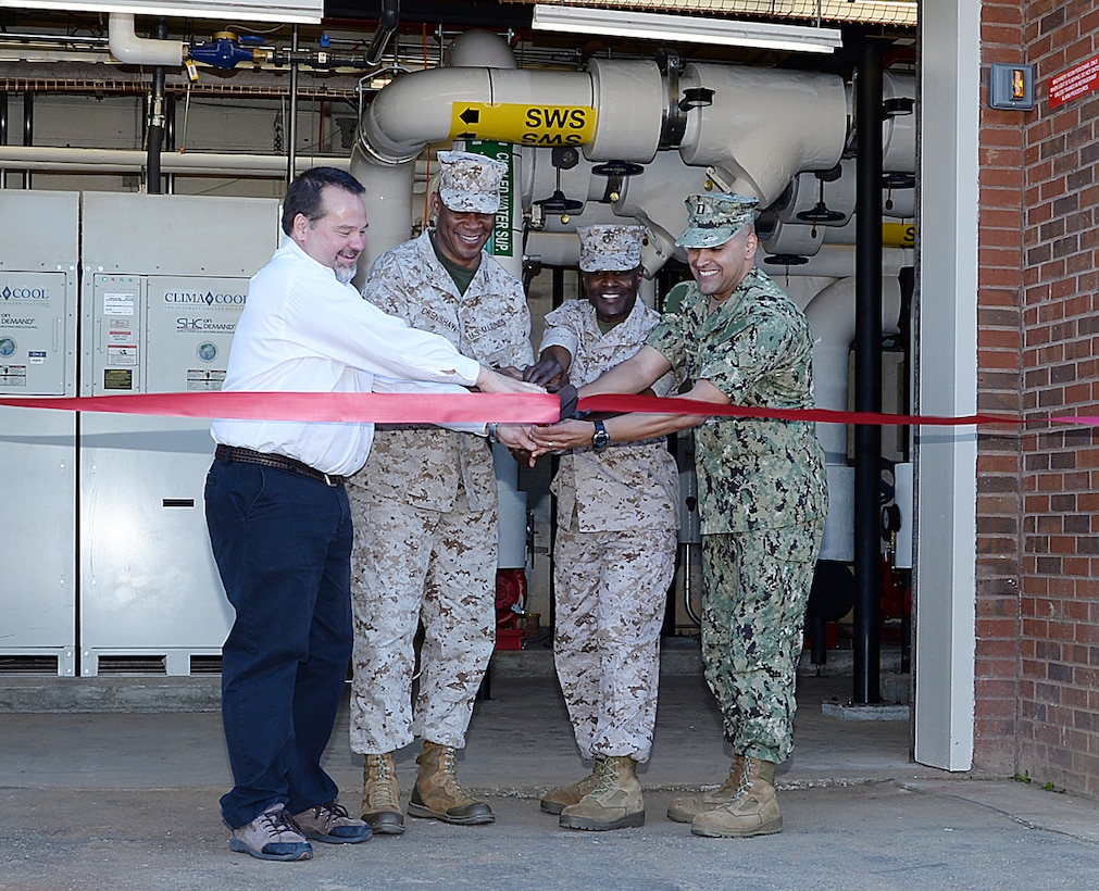 Military and civilian leaders officially mark the start of America’s first Borehole Thermal Energy Storage system - a state-of-the-art ground source heat pump system – with a ribbon-cutting ceremony at Building 3700, here, Oct. 19. From left: Chuck W. Hammock Jr., principal engineer, Andrews, Hammock & Powell, Inc., Macon, Ga.; Maj. Gen. Craig C. Crenshaw, (second from left) commanding general, Marine Corps Logistics Command;  Col. James C. Carroll III (third from left), commanding officer, MCLB Albany; and Navy Lt. Jose Centenorosado, director, Facilities Engineering and Acquisition Division, MCLB Albany.   