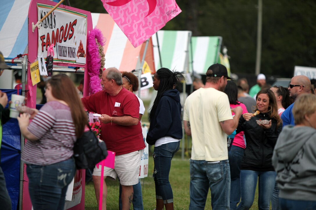 Participants enjoy Buffalo chicken wings during the 34th annual Havelock Chili Festival hosted by the Havelock Chamber of Commerce at the Walter B. Jones Park in Havelock, N.C., Oct. 16, 2015. Along with the assistance of volunteers from Cherry Point’s Single Marine Program, the chamber raises funds for local charities and sees who has the best chili and Buffalo wings. The winner goes on to compete in the International World Chili Championship. (U.S. Marine Corps photo by Lance Cpl. Jason Jimenez/Released)