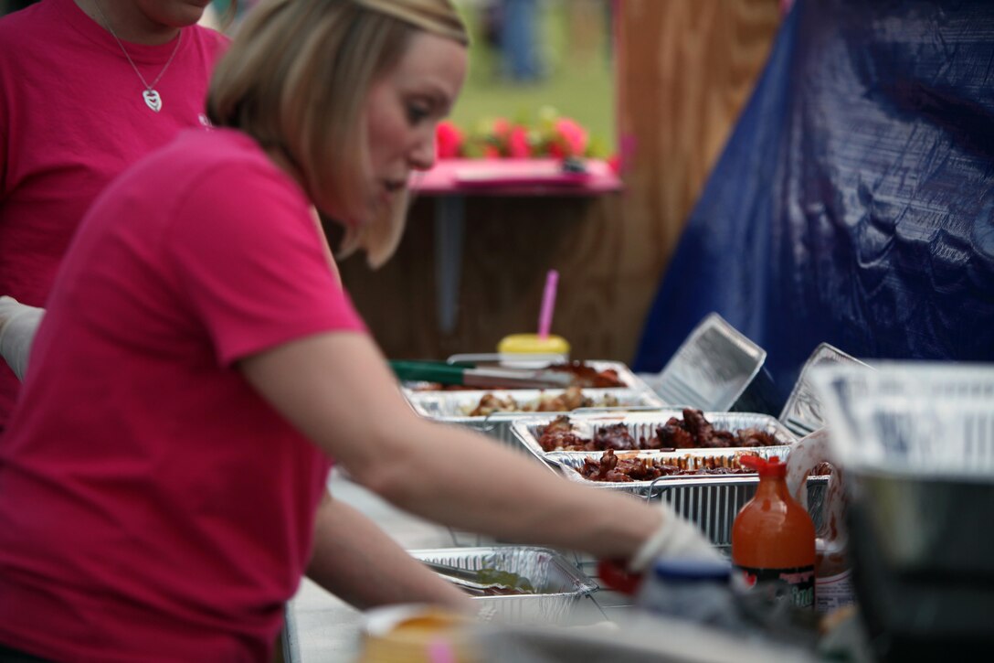 Kim Richesson readies the Buffalo chicken wings to be served during the 34th annual Havelock Chili Festival hosted by the Havelock Chamber of Commerce at the Walter B. Jones Park in Havelock, N.C., Oct. 16, 2015. Along with the assistance of Marine volunteers and other volunteers, the chamber raises funds for local charities and sees who has the best chili and Buffalo wings. The winner goes on to compete in the International World Chili Championship. Richesson is a cook in the festival. (U.S. Marine Corps photo by Lance Cpl. Jason Jimenez/Released)