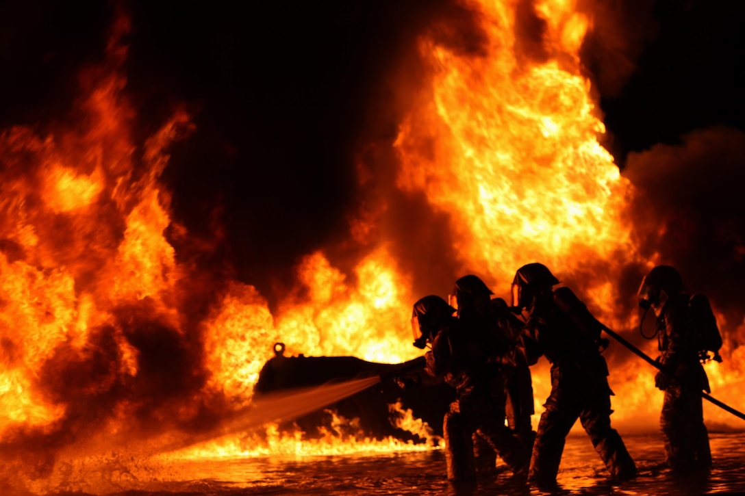 Aircraft rescue and firefighting Marines extinguish a fuel fire on Marine Corps Air Station Cherry Point, N.C., Oct. 16, 2015. The training exercise aimed to familiarize new Marines with the environment of a real fire and teach them to battle the heat until they annihilate the flames. U.S. Marine Corps photo by Pfc. Nicholas P. Baird