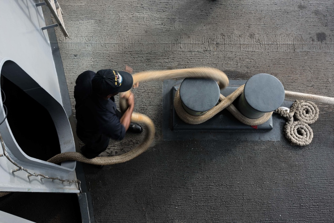 Navy Seaman Willie Cross heaves a line aboard the aircraft carrier USS John C. Stennis in the Pacific Ocean, Oct. 19, 2015. Cross is from St. Louis. U.S. Navy photo by Petty Officer 3rd Class Kenneth Rodriguez Santiago
