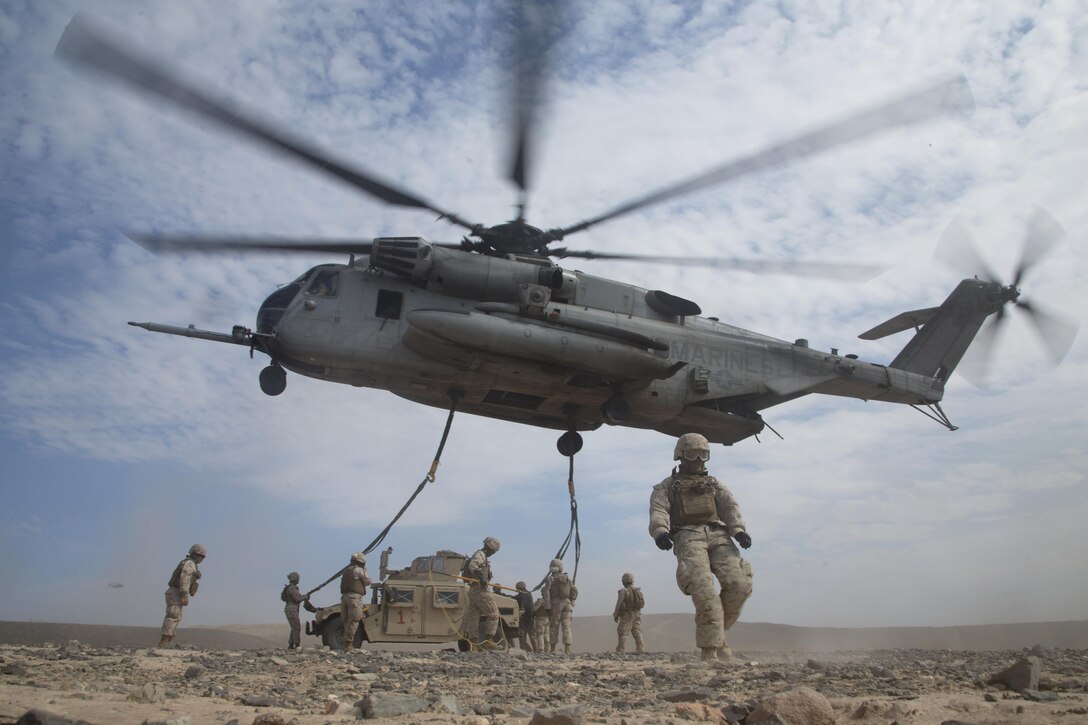 Marines prepare a Humvee for transport via sling load underneath a CH-53E Super Stallion helicopter during an assault support tactics exercise at Landing Zone Bull, Chocolate Mountain Aerial Gunnery Range, Calif., Oct. 12, 2015. The Marines are with Landing Support Company, 1st Transportation Support Battalion, 1st Combat Logistics Regiment. U.S. Marine Corps photo by Cpl. Summer Dowding