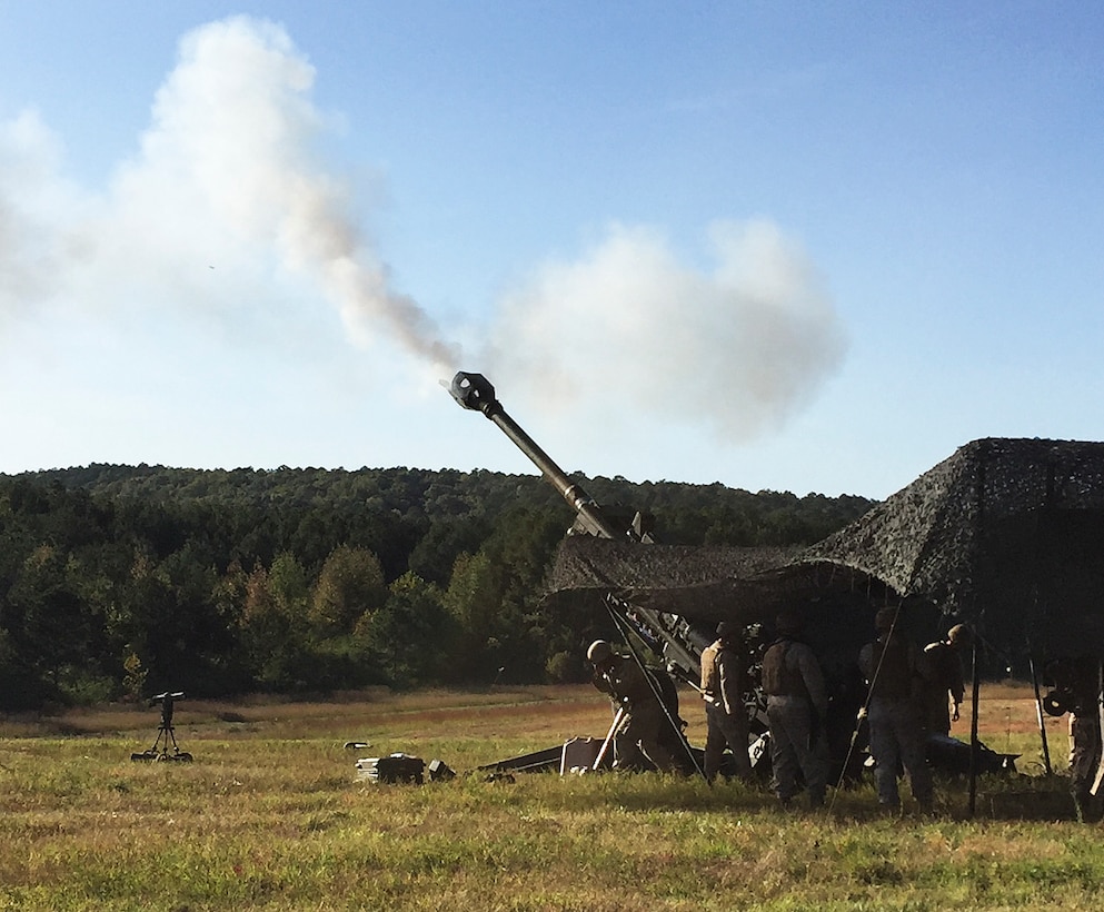 Marines from Battery M, 3rd Battalion, 14th Marine Regiment, 4th Marine Division, fire off a round at Pelham Range in Anniston, Alabama, on Oct. 16, 2015. The Marines fired the howitzer during annual training to keep their skills sharp and ready to use artillery at any time. 