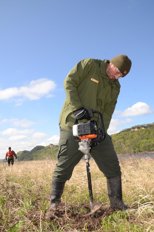 Dan Reburn, forestry student, drills holes during the
spring tree planting in Pool 8 on April 20, 2012. The Corps will plant more than 4,900 seedlings this spring on the islands, which are located in Pool 8.