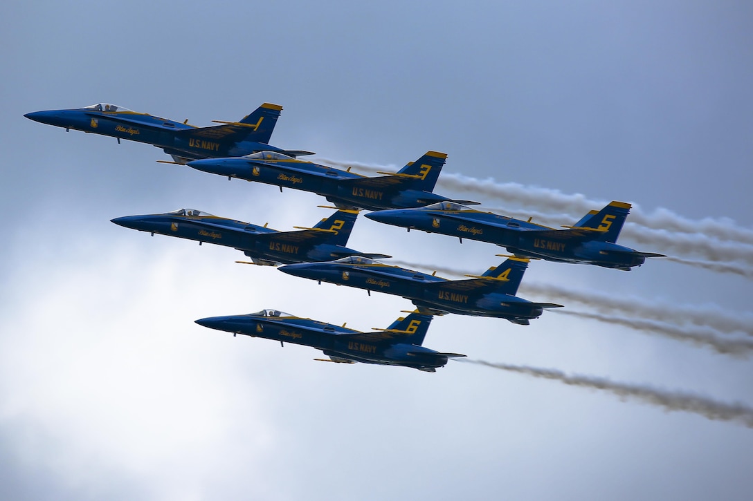 Members of the U.S. Navy’s flight demonstration squadron, the Blue Angels, perform aerobatic maneuvers in their F/A-18 Hornets during the 2015 Kaneohe Bay Air Show on Marine Corps Base Hawaii, Oct. 17. 2015. U.S. Marine Corps photo by Lance Cpl. Harley Thomas