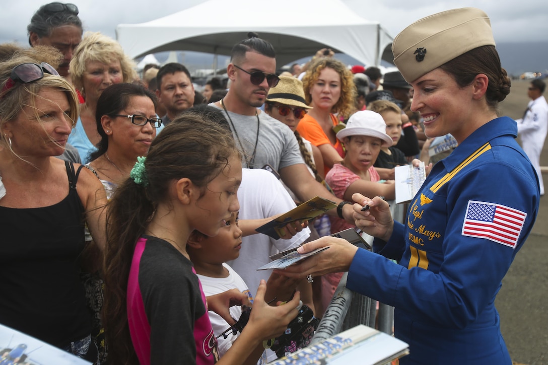 Marine Corps Capt. Corrie Mays, the events coordinator for the Blue Angels, the U.S. Navy’s flight demonstration squadron, signs autographs during the 2015 Kaneohe Bay Air Show at Marine Corps Base Hawaii, Oct. 17. 2015. U.S. Marine Corps photo by Lance Cpl. Harley Thomas