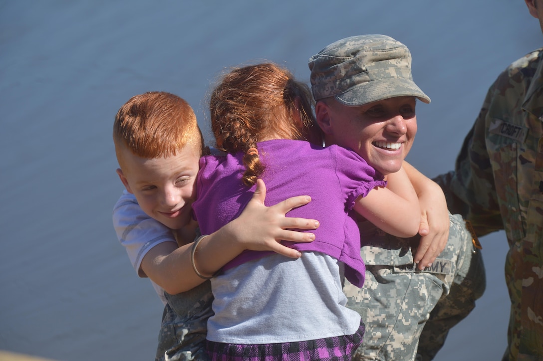 U.S. Army Maj. Lisa Jaster is congratulated by her children following graduation from Ranger School on Fort Benning, Ga., Oct. 16, 2015. Jaster is the third female to graduate Ranger School. (U.S. Army photo by Staff Sgt. Alex Manne/ Released)