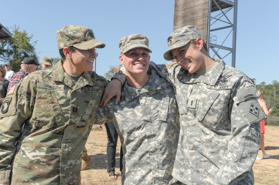 From left, U.S. Army Capt. Kristen Griest, Maj. Lisa Jaster and 1st Lt. Shaye Haver share a moment following Jaster's graduation from Ranger School on Fort Benning, Ga., Oct. 16, 2015. Griest, Haver and Jaster are currently the only female Ranger School graduates. (U.S. Army photo by Staff Sgt. Alex Manne/ Released)