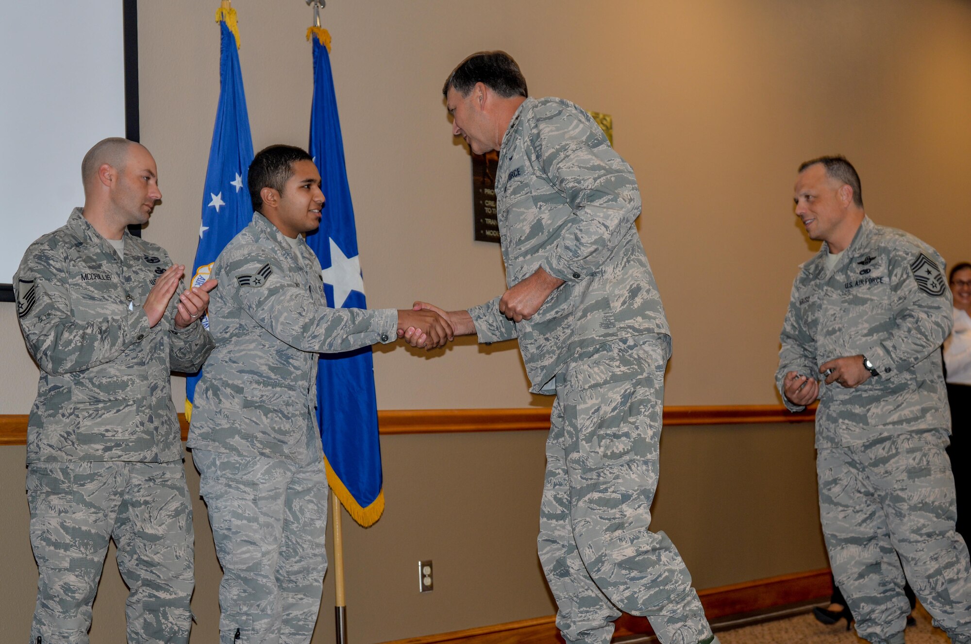 Lt. Gen. Brad Heithold, commander of Air Force Special Operations Command, presents his coin to Landing Zone staff for their assistance in the execution of the Commando Rally Oct. 16, 2015 at Cannon Air Force Base, N.M. For the first time in five years, Cannon hosted the 2015 Commando Rally, a forum for AFSOC members to meet and discuss future, past and present plans, issues and solutions facing the command. (U.S. Air Force photo/Airman 1st Class Shelby Kay-Fantozzi)