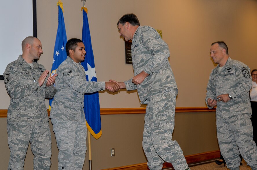 Lt. Gen. Brad Heithold, commander of Air Force Special Operations Command, presents his coin to Landing Zone staff for their assistance in the execution of the Commando Rally Oct. 16, 2015 at Cannon Air Force Base, N.M. For the first time in five years, Cannon hosted the 2015 Commando Rally, a forum for AFSOC members to meet and discuss future, past and present plans, issues and solutions facing the command. (U.S. Air Force photo/Airman 1st Class Shelby Kay-Fantozzi)