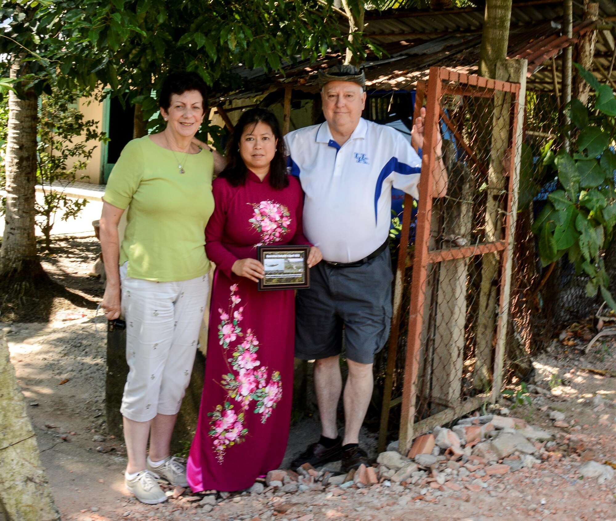 From left, retired Lt. Col. Regina Aune, Aryn Lockhart and retired Chief Master Sgt. Ray Snedegar pause for a photo after showing their respects at a shrine for those lost after the crash of a C-5A in Saigon, Vietnam, in April 1975.