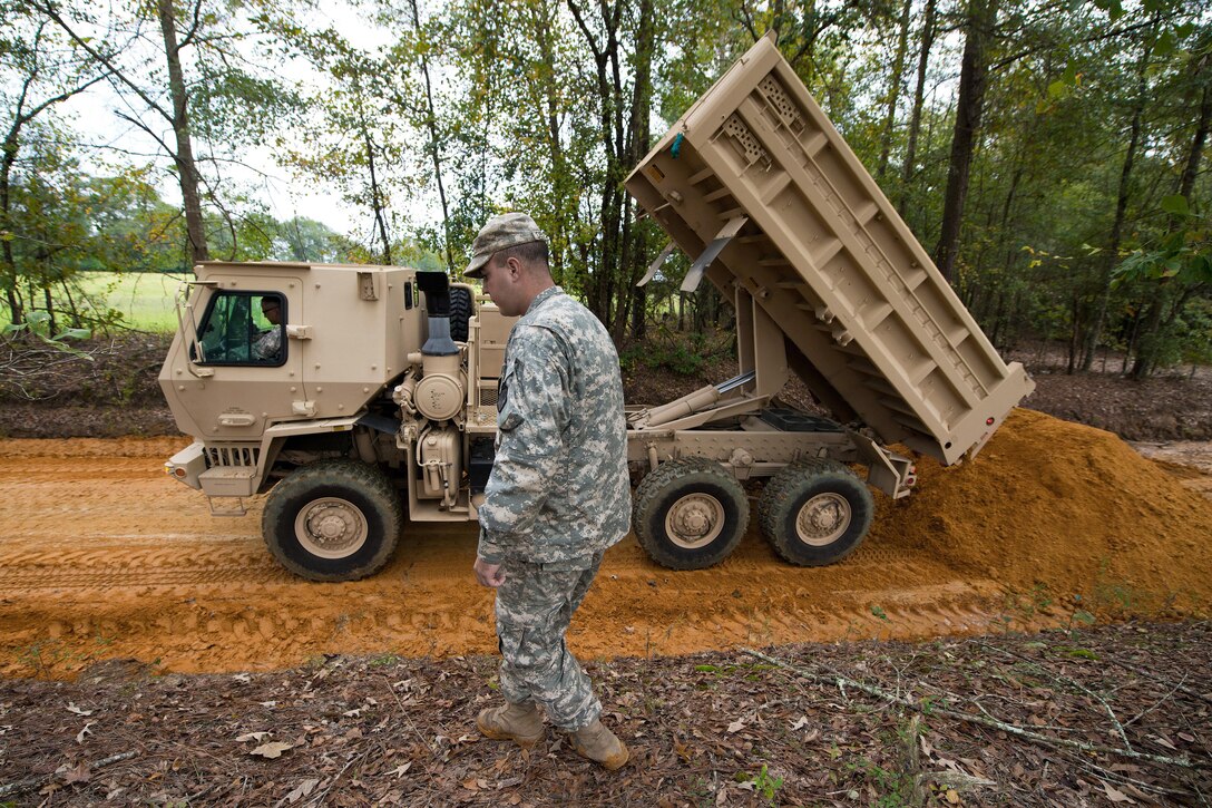 South Carolina Army National Guardsmen haul clay dirt to rebuild roads that were washed out in Swansea, S.C., Oct. 13, 2015. The Guard was activated to support emergency management agencies and local first responders after historic statewide flooding in early October. South Carolina Air National Guard photo by Tech. Sgt. Jorge Intriago