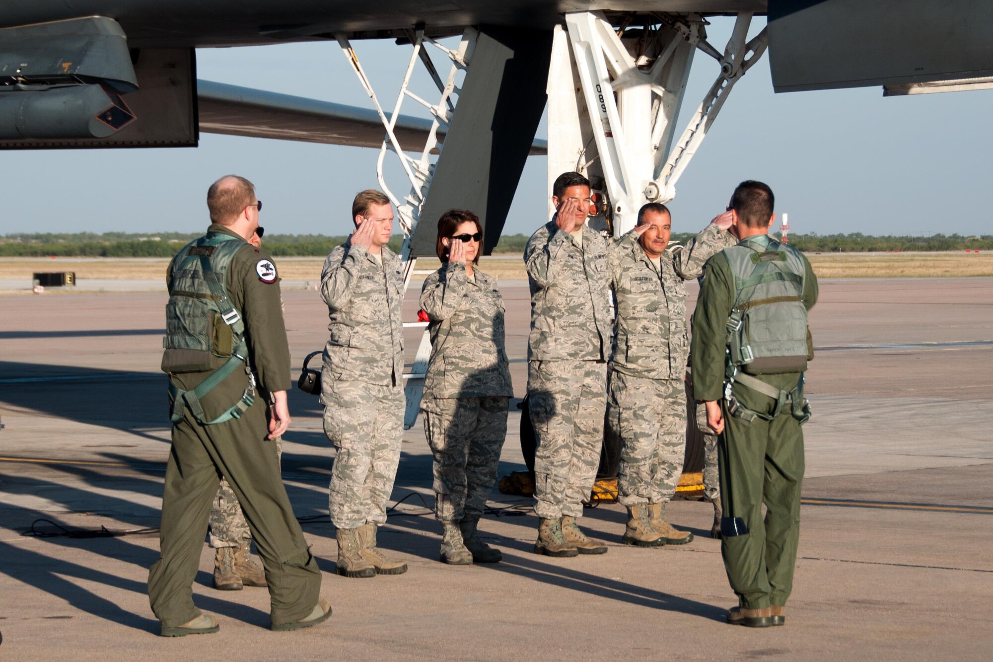 U.S. Air Force Reserve Col. Denis Heinz, commander of the 489th Bomb Group (right), salutes the maintenance team of the 489th flag ship, a B-1 Lancer. The first flight for the 489th was on Oct. 18, 2015 from Dyess Air Force Base, Texas. After 70 years of inactivation, the 489th BG reactivated as a Reserve unit the day before the flight. The 489th BG is assigned to the 307th Bomb Wing who is an associate unit to the active duty 7th Bomb Wing. (U.S. Air Force photo by Master Sgt. Laura Siebert/Released)