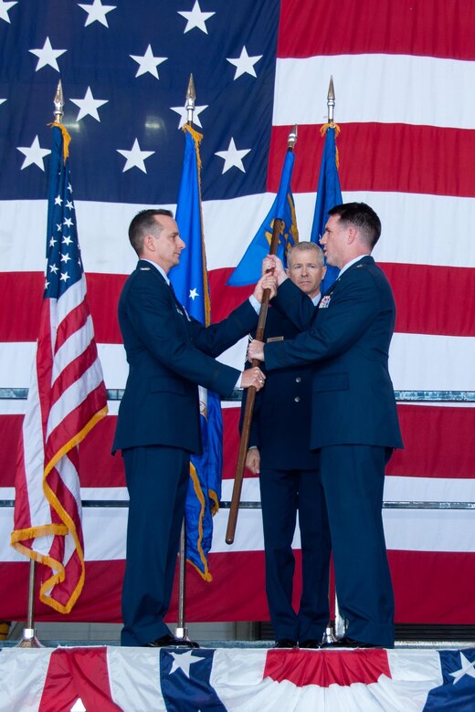 U.S. Air Force Reserve Col. Denis Heinz, commander of the 489th Bomb Group, presents the 345th Bomb Squadron’s guidon to Lt. Col. Brian McClanahan on Oct. 17, 2015 at Dyess Air Force Base, Texas. McClanahan assumes command of the 345th Bomb Squadron, the only B-1 bomber unit in the Air Force Reserve. The 345th Bomb Squadron is assigned to the 489th Bomb Group which falls under the 307th Bomb Wing. The 307th Bomb Wing is the only dual bomber mission wing in the Air Force. (U.S. Air Force photo by Master Sgt. Laura Siebert/Released)