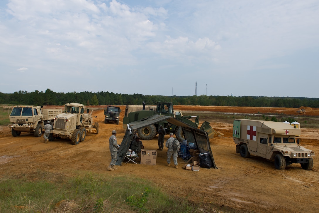 South Carolina Army National Guardsmen take a break at their rest area after hauling clay dirt to rebuild roads that were washed out in Swansea, S.C., Oct. 13, 2015. Recovery efforts continue after historic statewide flooding in early October. South Carolina Air National Guard photo by Tech. Sgt. Jorge Intriago