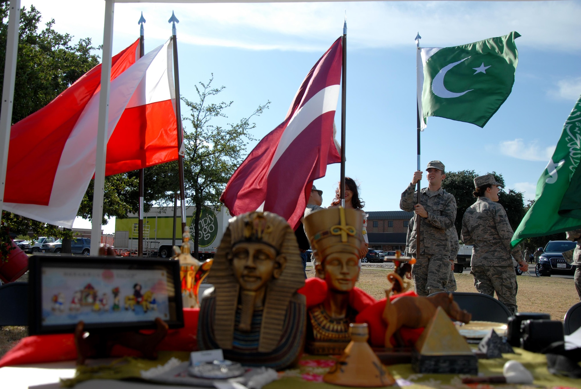 Volunteers set up national flags for Multicultural Day outside the Western Winds Dining Facility on Goodfellow Air Force Base, Texas, Oct. 19, 2015. The event provided individuals the opportunity to celebrate different cultures from around the world. (U.S. Air Force photo by Senior Airman Joshua Edwards/Released)