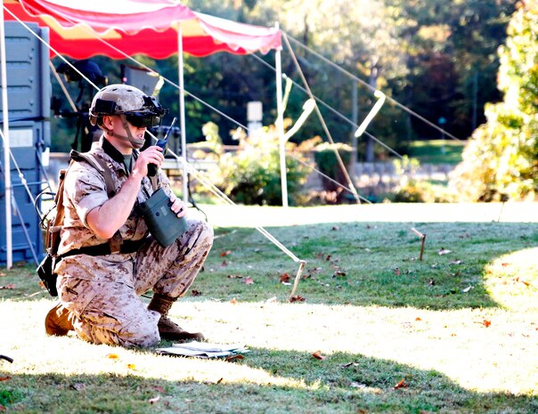 Capt. Jerald Feehery, a project officer with the Marine Corps Warfighting Laboratory, demonstrates the Augmented Immersive Team Trainer Oct. 15 aboard Marine Corps Base Quantico, Virginia. AITT uses augmented reality to superimpose virtual objects—from aircraft to buildings—onto a real environment. The system is being transferred from the Office of Naval Research to Marine Corps Systems Command’s Training Systems for further testing and development before it is fielded and used to train Marine forward observers and tactical air controllers.