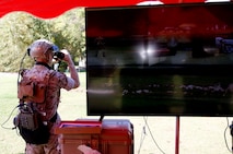 Capt. Jerald Feehery, a project officer with the Marine Corps Warfighting Laboratory, demonstrates the Augmented Immersive Team Trainer Oct. 15 aboard Marine Corps Base Quantico, Virginia. AITT uses augmented reality to superimpose virtual objects—from aircraft to buildings—onto a real environment. The system is being transferred from the Office of Naval Research to Marine Corps Systems Command’s Training Systems for further testing and development before it is fielded and used to train Marine forward observers and tactical air controllers.