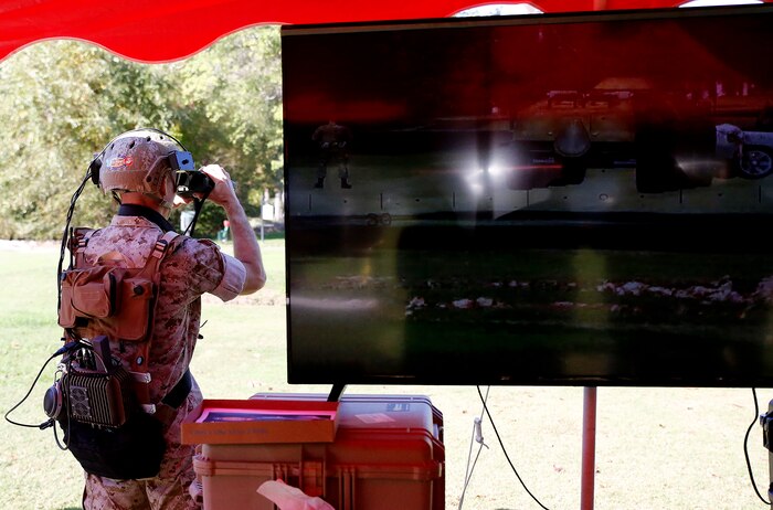 Capt. Jerald Feehery, a project officer with the Marine Corps Warfighting Laboratory, demonstrates the Augmented Immersive Team Trainer Oct. 15 aboard Marine Corps Base Quantico, Virginia. AITT uses augmented reality to superimpose virtual objects—from aircraft to buildings—onto a real environment. The system is being transferred from the Office of Naval Research to Marine Corps Systems Command’s Training Systems for further testing and development before it is fielded and used to train Marine forward observers and tactical air controllers.